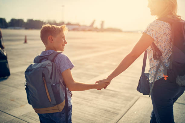 Mother and son walking on airstrip