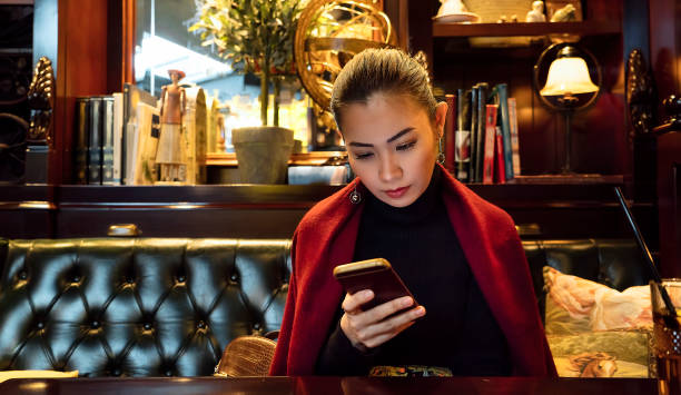 Woman using mobile phone in a luxurious restaurant