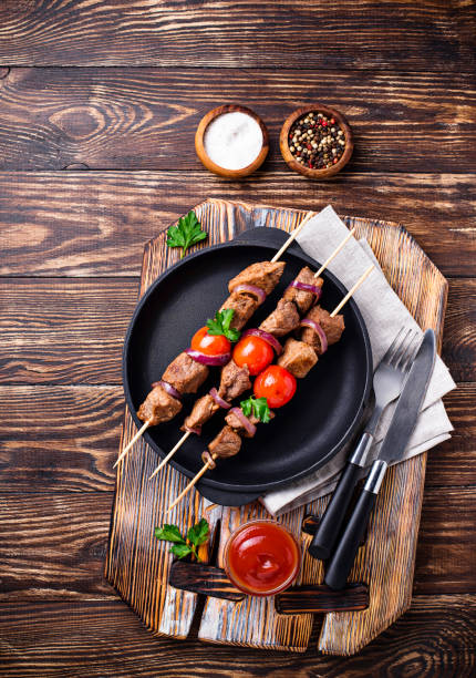 istock Grilled shish kebab skewers  with tomatoes 1132327828