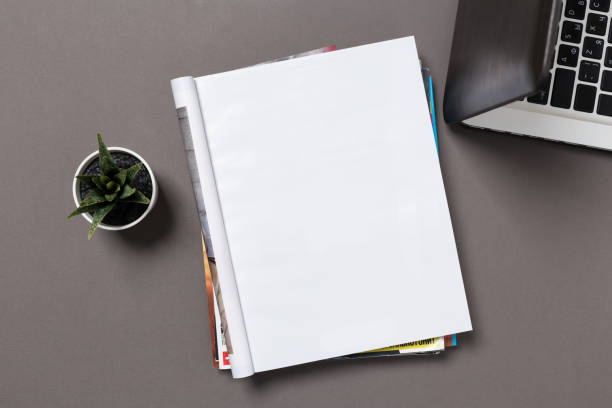 istock office desk top view with blank notebook  isolated on gray, with clipping path, changeable background. Blank page or notepad on wood background. Blank page or notepad for mockups or simulations. 1132328247