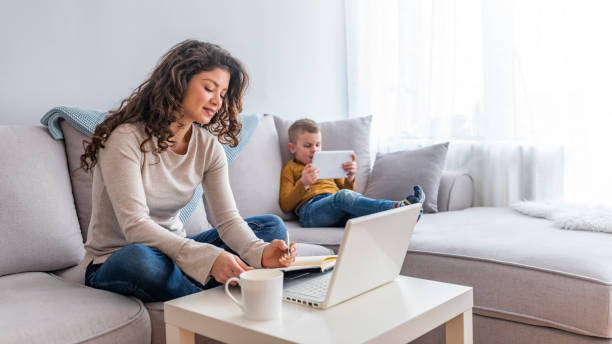 istock Shot of a boy playing while his mother is working on a computer. 1132329821