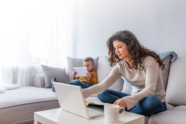 istock Shot of a boy playing while his mother is working on a computer. 1132330281