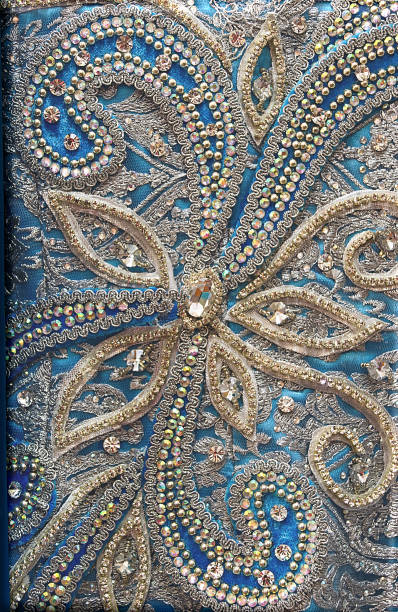 istock White and silver floral design on blue textile background 1132330400