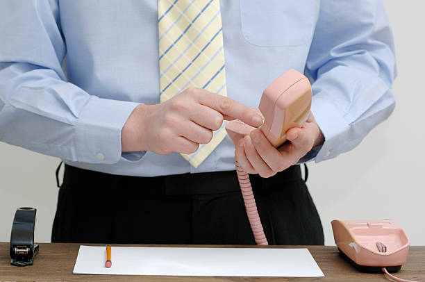 businessman at office desk dialling retro telephone office male in shirt and tie at office work desk dialling telephone keypad dialling phone stock pictures, royalty-free photos & images