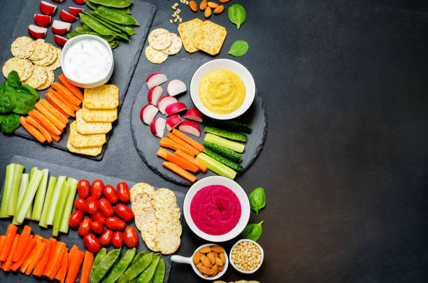 istock Variation of healthy vegan snacks. Vegetables, crackers, dip and hummus 1132330705