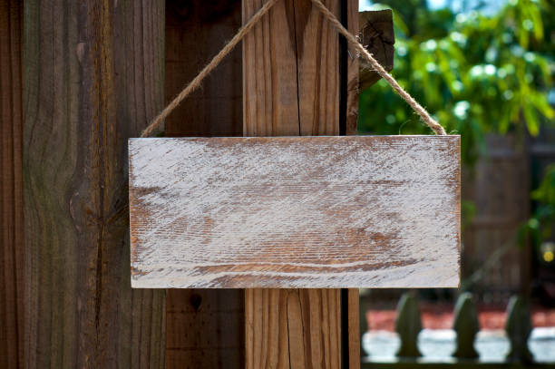 istock white empty rustic sign hanging from wooden fence 1132331792
