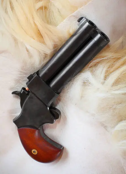 Photo of Derringer hand gun for self defense on sheep fur.