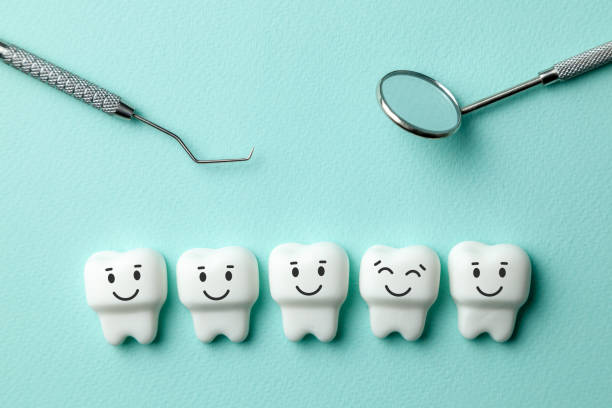 istock Healthy white teeth are smiling on green mint background and dentist tools mirror, hook. 1132332384