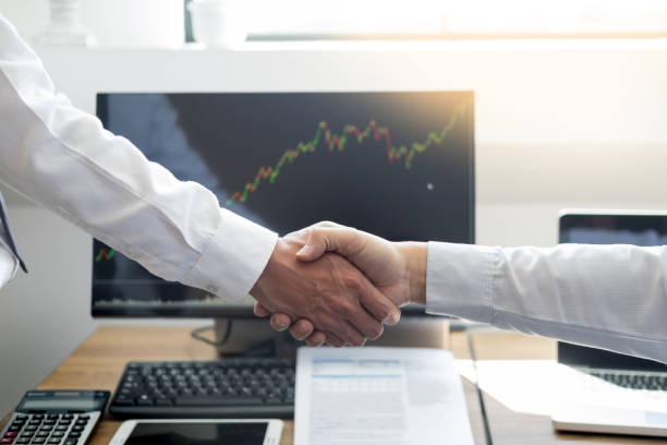 istock Midsection Of Businessman Shaking Hands At Office 1132333727