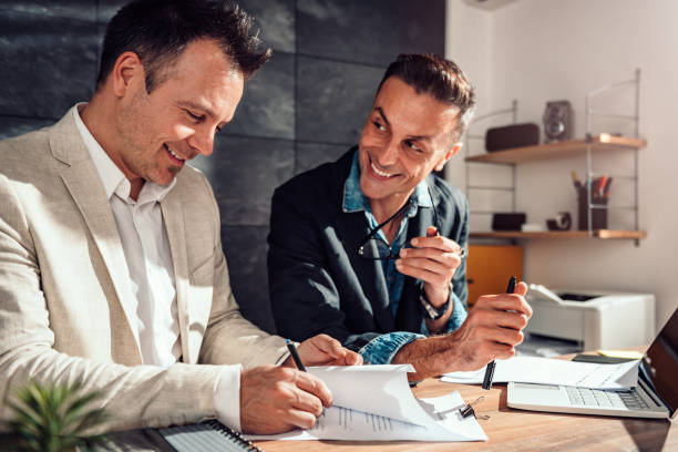 istock Client singing contract at real estate agent office 1132336605