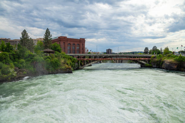 The Spokane river in spring flood near downtown Spokane, Washington The Spokane river in spring flood near downtown Spokane, Washington, USA spokane river stock pictures, royalty-free photos & images