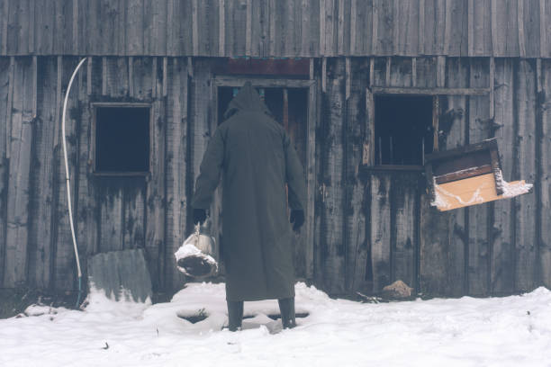 istock Mysterious man standing in front of ruined house 1132340747
