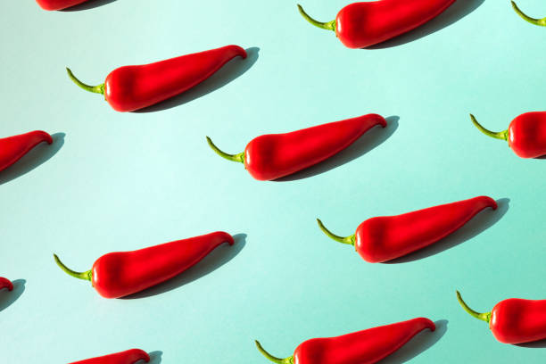 istock Red chili pepper on a green background isometric. 1132341454