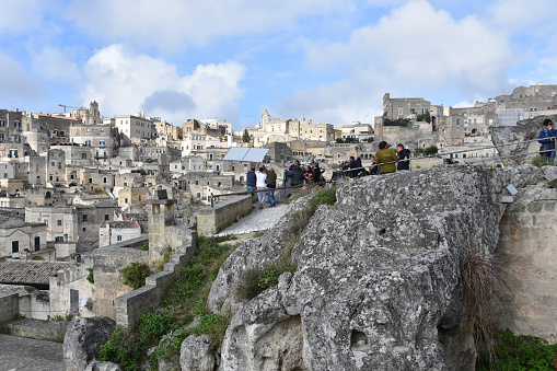 Matera, Italy - November 10, 2018: Film crew on set shooting movie; scene with lead actors overlooking the old town of Matera - a UNESCO world heritage site and European capital of culture 2019