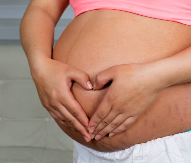istock Pregnant wrap her arms around the belly. 1132341754