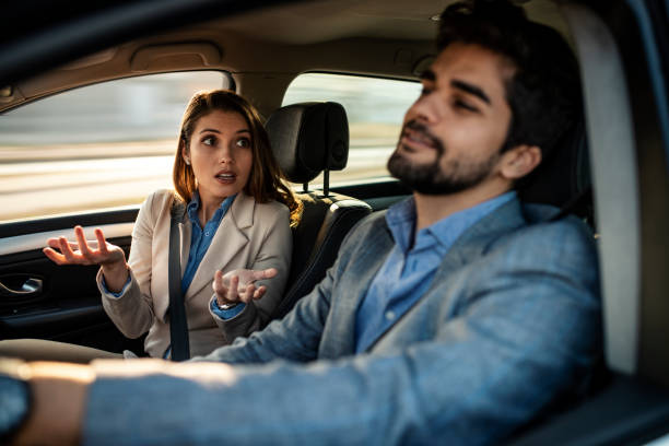 istock A man driving while a female passenger is fussing about 1132342785