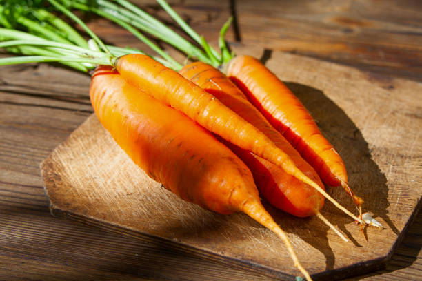 istock raw ripe carrots on  wooden table 1132343212