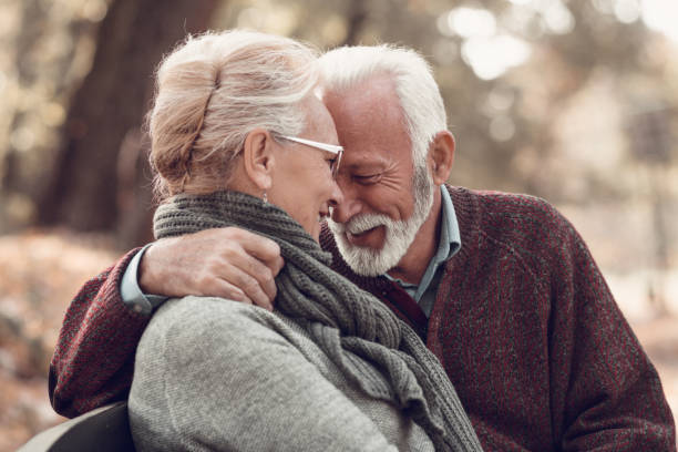 istock Happy autumn senior couple on park bench 1132343666