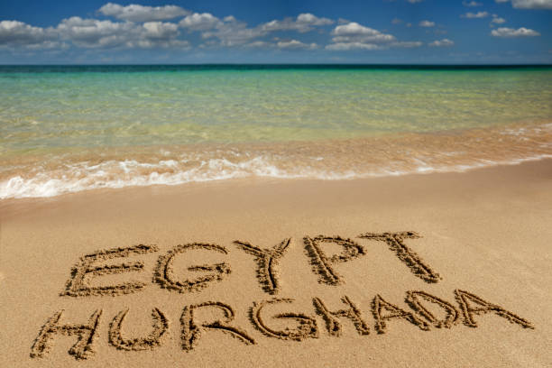 Egypt Hurghada written on sand of beach.