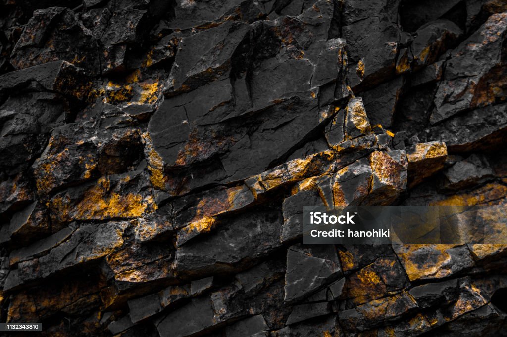 black rock background with golden / yellow color black rock background with golden / yellow color - Gold Colored Stock Photo