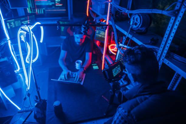 istock The process of filming. Cameraman shoots a scene with a hacker. Backstage 1132346763