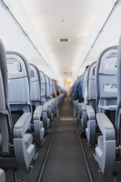 istock airline passenger seats and aisle 1132348598