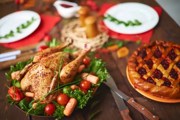 Homemade pastry and roasted poultry on festive table