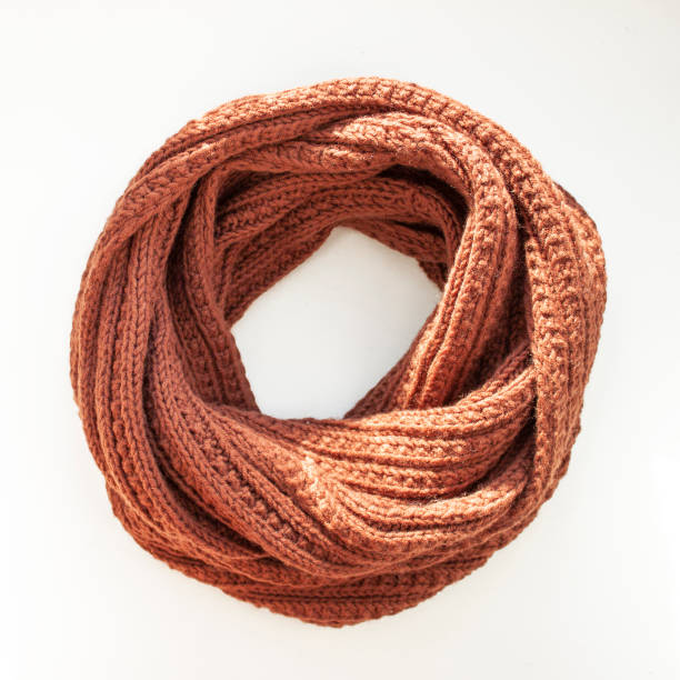 istock Brown-red knitted scarf on white background. Snood scarf 1132350426