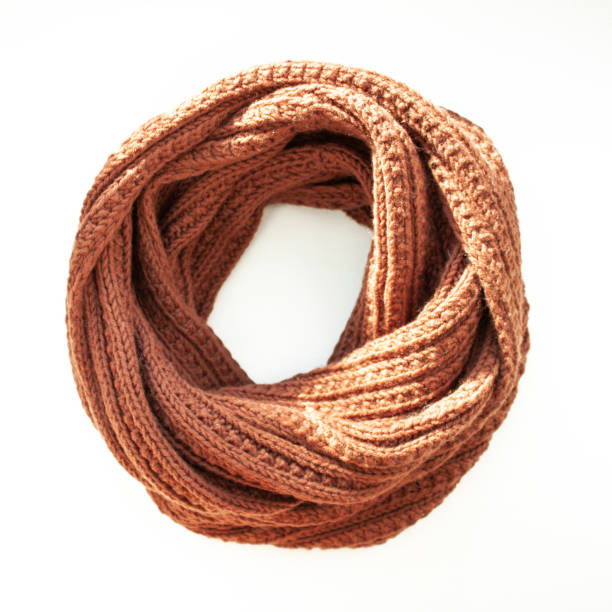 istock Brown-red knitted scarf on white background. Snood scarf 1132350432
