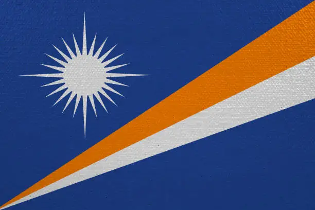 Marshall Islands flag on canvas. Patriotic background. National flag of Marshall Islands