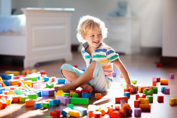 istock Child playing with colorful toy blocks. Kids play. 1132351603