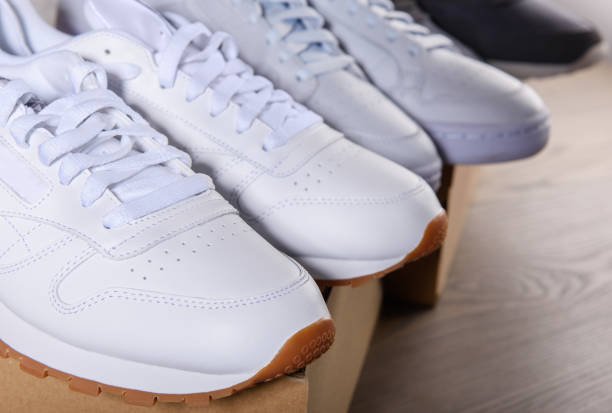Sneakers of different models and colors are in a row.