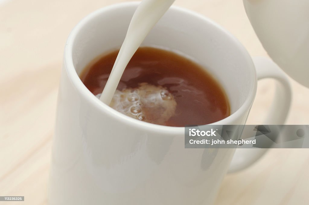 Mug of tea, coffee with milk pouring in British Culture Stock Photo