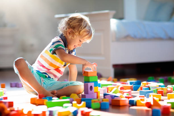 istock Child playing with colorful toy blocks. Kids play. 1132353348