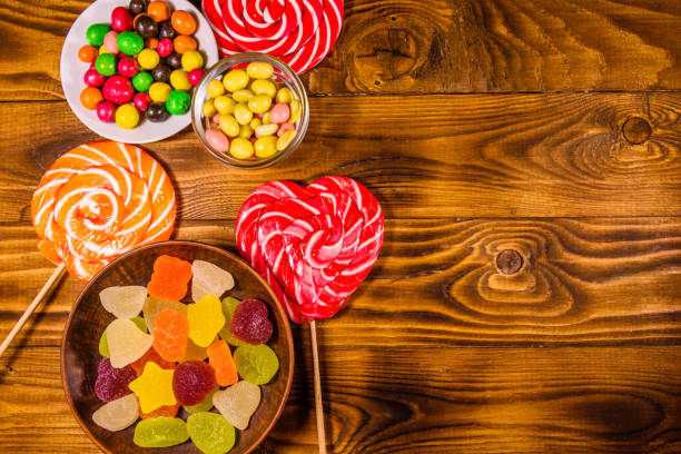 istock Different sweet candies on a wooden table. Top view 1132354609