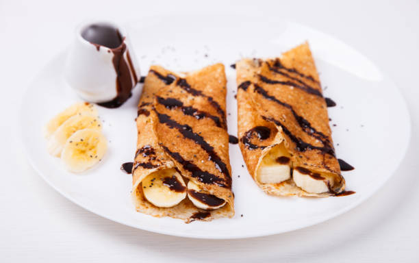 istock Pancakes with banana and chocolate topping.selective focus. 1132354704