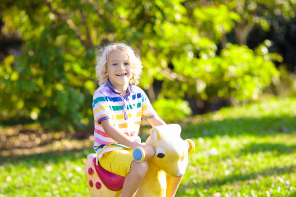 istock Kids on playground. Child on swing. 1132355103