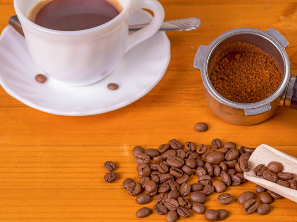 istock Coffee beans, dispenser and mug on a wooden background 1132355823