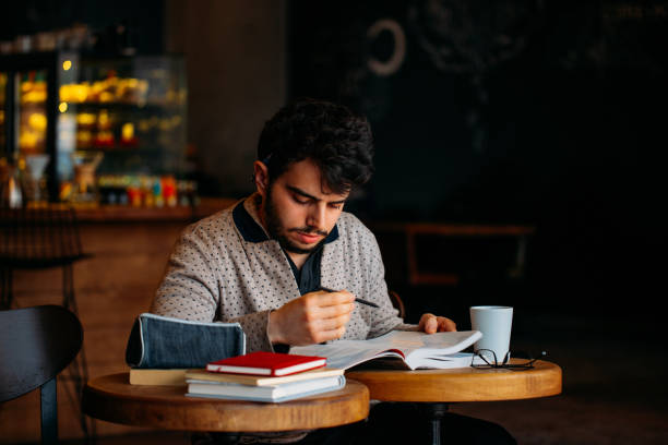 istock Young Student Preparing for Exam in Cafe 1132356375