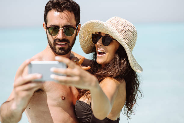 istock couple take a selfie on the beach in summer 1132357446