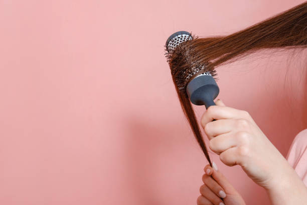 istock comb for hair volume in female hand 1132357843
