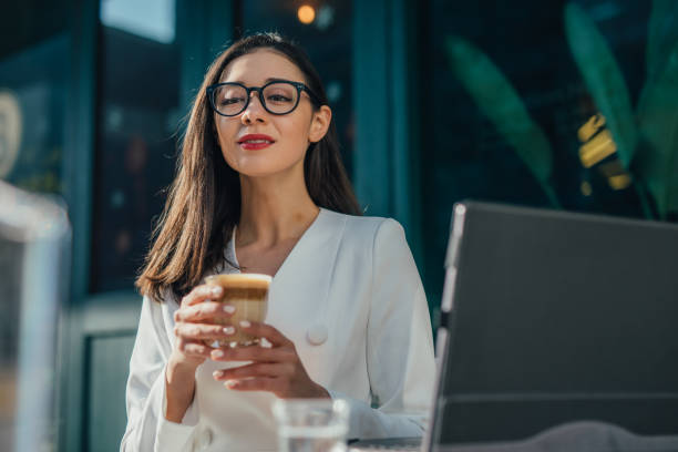 istock Young businesswoman is drinking coffee 1132360386