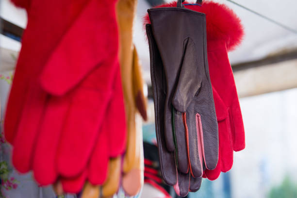 Close up display of fabric and leather gloves .