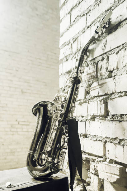 istock Saxophone On The Brick Wall Background - Vintage Toned Image 1132362558