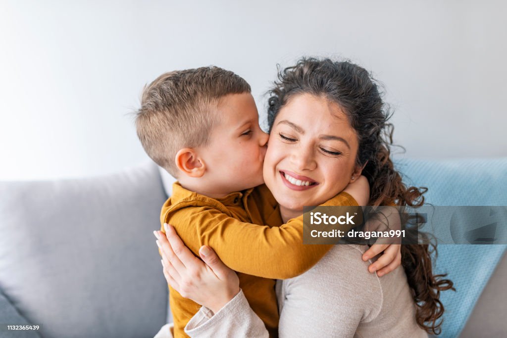 Son is kissing his mother. Son is kissing his mother. The kind of love that can't be described, only felt. Mom and son. Happy mother's day! Mother hugging her child Mother Stock Photo