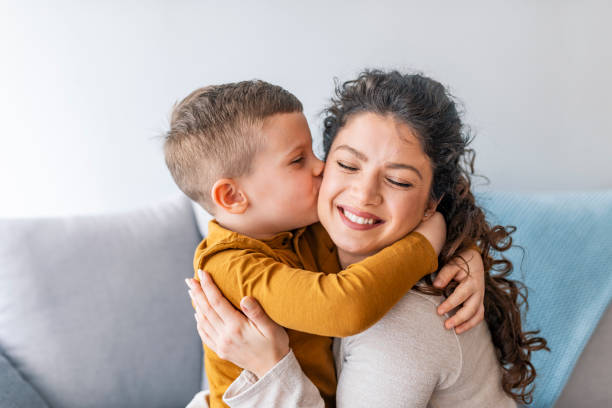 Son is kissing his mother. Son is kissing his mother. The kind of love that can't be described, only felt. Mom and son. Happy mother's day! Mother hugging her child playful photos stock pictures, royalty-free photos & images