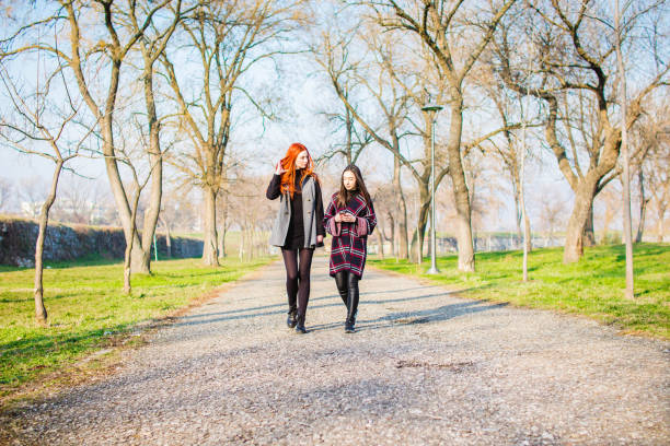 istock Two young woman in a park 1132367503