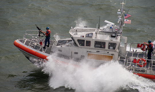 A US Coast Guard patrol boat cuts through the waters of the Charleston, SC harbor.\n\nCharleston, SC, USA.\nAugust 12, 2018.