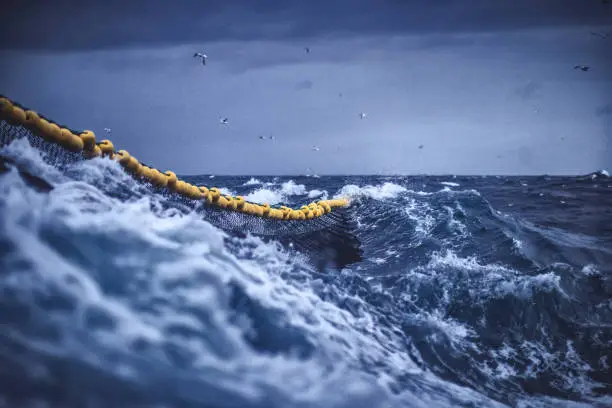 Photo of Fish boat vessel fishing in a rough sea