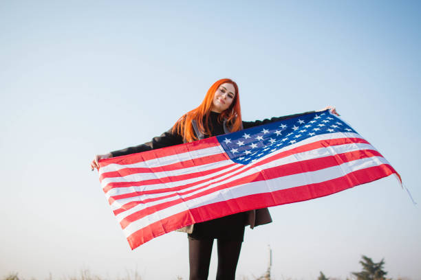 istock Young woman holding USA flag 1132371576